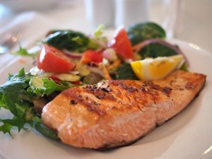 salmon-with-vegetables-and-lemon-on-white-table
