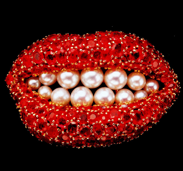 A boca cravejada de rubis e recheada de pérolas é na verdade um broche.
