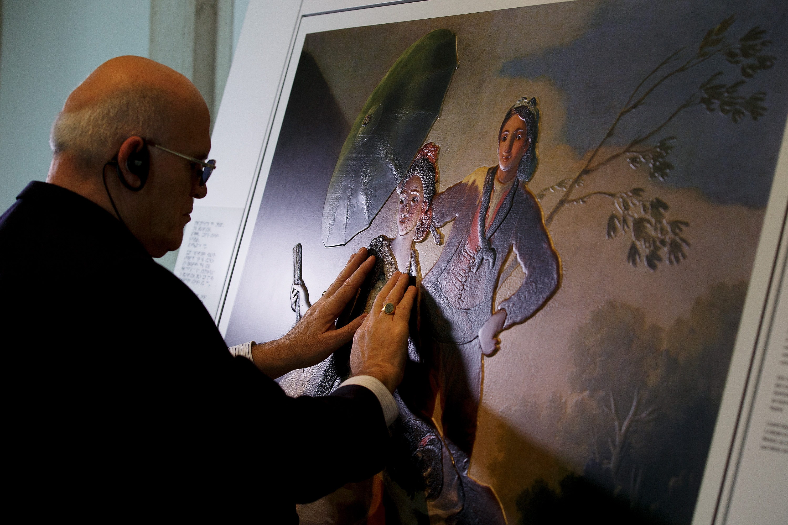 MADRID, SPAIN - FEBRUARY 10: A blind person feels with his hands a copy of 'The Parasol' of Goya at The Prado Museum on February 10, 2015 in Madrid, Spain. 'Hoy toca el Prado' (Touch The Prado) allows blind or vision-impaired visitors to explore with their hands the copies of six masterworks. The copies were created using a technique called 'Didu' which provides texture and volume to the paintings. (Photo by Pablo Blazquez Dominguez/Getty Images)