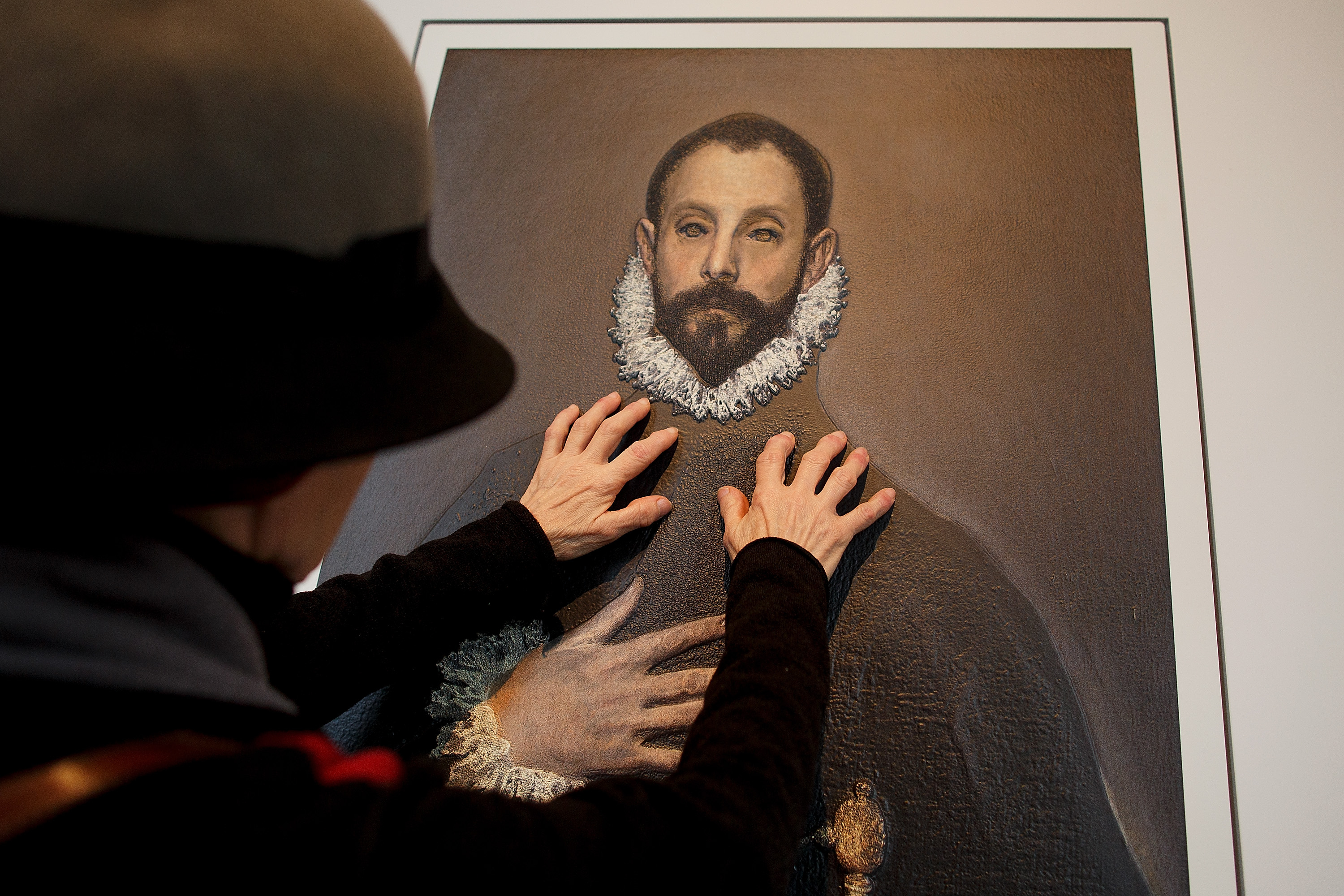 MADRID, SPAIN - FEBRUARY 10: A blind person feels with her hands a copy of 'The gentleman with his hand on his chest' of El Greco at The Prado Museum on February 10, 2015 in Madrid, Spain. 'Hoy toca el Prado' (Touch The Prado) allows blind or vision-impaired visitors to explore with their hands the copies of six masterworks. The copies were created using a technique called 'Didu' which provides texture and volume to the paintings. (Photo by Pablo Blazquez Dominguez/Getty Images)