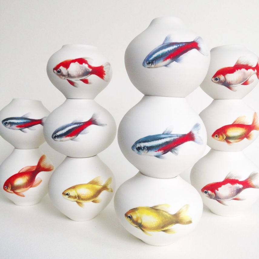 Artista pinta peixes em vasos para dar movimento às peças 