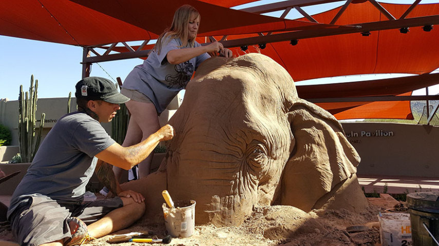 A obra do elefante jogando xadrez com um rato, dos artistas Ray Villafane e Sue Beatrice, é feita de areia e é em tamanho real